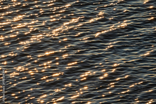 Bild auf Leinwand Golden sunlight sparkling on the dark blue water surface of the Baltic Sea creat