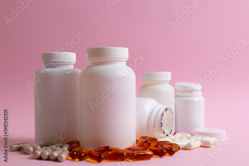 Vitamins On Neutral Background. Assorted Supplement Bottles With Capsules On Plain Backdrop