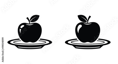 Two black apples on plates a striking silhouette