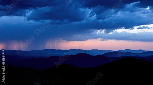 Darkening mountainous landscape captures a heavy rain shower at twilight