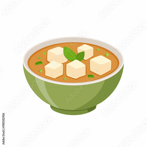 Green bowl with Japanese miso soup, tofu cubes, and basil garnish on a white background.