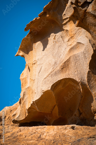 A rock, desert sandy formations, a natural arch Arco de las Penitas in the daylight.