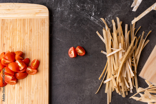 dried pasta and tomatoes prepped on a kitchen bench