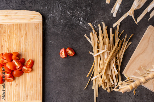 dried pasta and tomatoes prepped on a kitchen bench