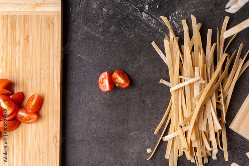 dried pasta and tomatoes prepped on a kitchen bench