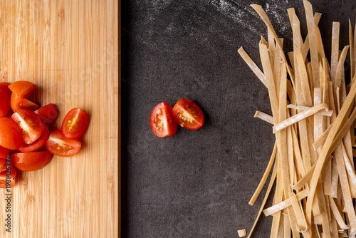dried pasta and tomatoes prepped on a kitchen bench