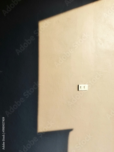 Minimalist Interior Wall Background with Natural Sunlight Shadow and Light Switch with Copy Space for Aesthetic Design