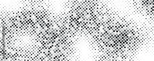 This abstract image displays a dense grainy pattern of black and white dots resembling static or noise