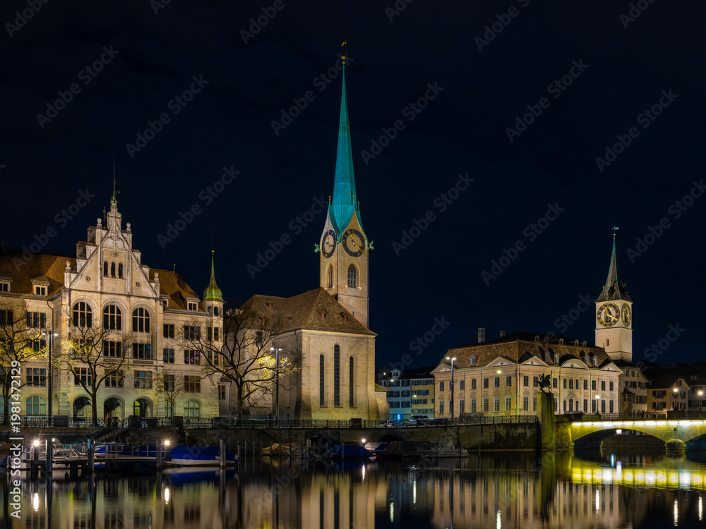 Fototapeta premium Quiet River Reflecting Sparkling City Lights And Historic Architecture