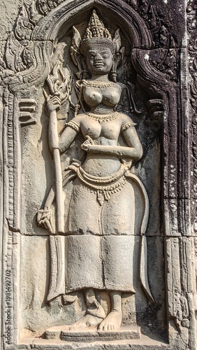 A stone statue of a figure in a traditional outfit
