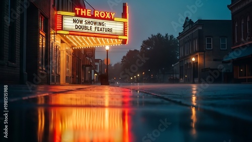 vintage movie theater marquee glows warmly on a rainy evening, its lights reflecting on the wet pavement.
