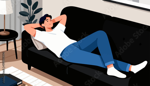 Man relaxes on black couch, arms behind head. Wears white tee and blue jeans, bare feet. Cozy room has plant, lamp, and window. Quiet moment of rest, calm and content. Ideal for lifestyle, wellness
