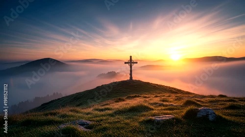 Cross on hill at sunrise landscape.