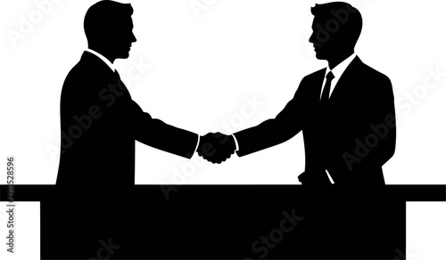 A silhouette of two businessmen shaking hands over a desk representing agreement and partnership