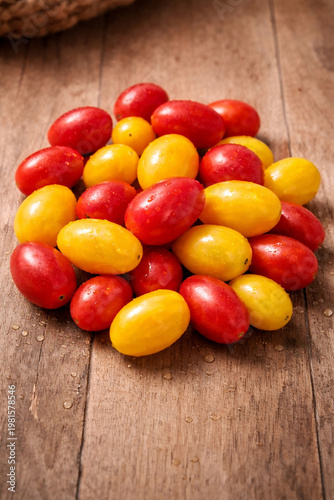 Fresh Red and Yellow Cherry Tomatoes on Rustic Wooden Background Authentic photograph not AI Generationen 