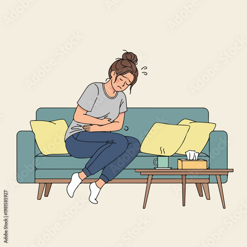 Woman on sofa clutching her stomach suffering from painful abdominal discomfort