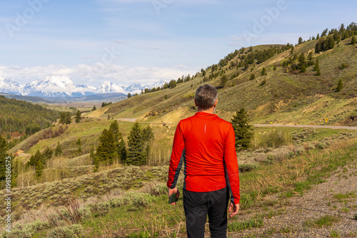 Hiker in Red Jacket Overlooking Grand Teton National Park Landscape