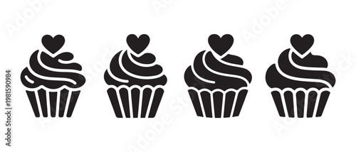 Cupcakes with swirled frosting and heart toppers on white background.