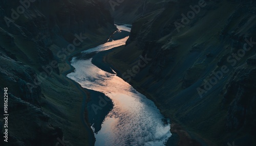 Glowing River Winding Through Dark Shadowy Landscape at Dusk.
