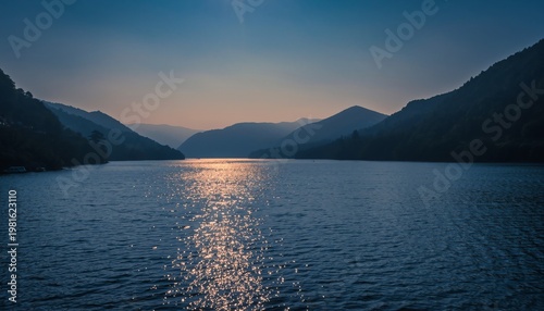 Serene Lake Reflecting Vibrant Sunset Over Towering Mountains.