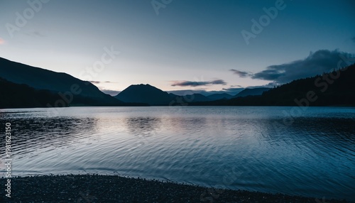 Serene Mountain Lake at Twilight with Calm Reflections and Peaks.