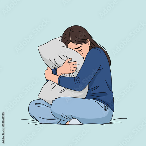 A sad woman sitting and crying while hugging a pillow for emotional comfort