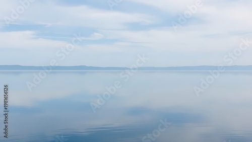 mistreat. A perfectly flat lake mirroring the sky with a seamless horizon. travel magazines, destination branding, designed for outdoor magazines and nature guides and travel destination branding.