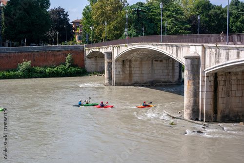 Kayaking in the river Adige in Verona passing underneath the Garibaldi bridge.