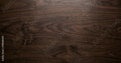 Fotografía Close-up of dark walnut wood surface showcasing natural grain patterns and textures, ideal for backgrounds and design projects highlighting natural materials