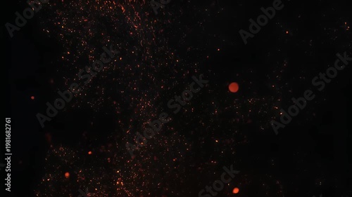 Dynamic glowing fire sparks flying up on dark black background