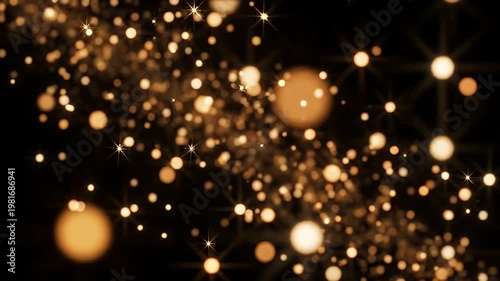 Golden glowing bokeh and sparkling light particles on black
