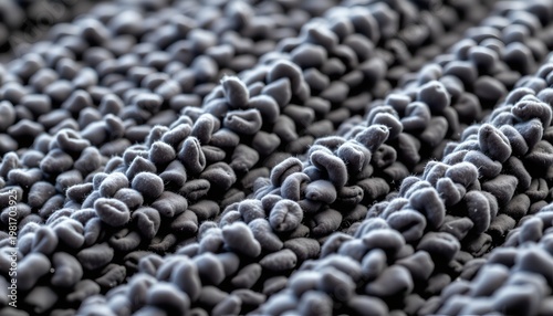 An array of blue beads against a contrasting dark background.