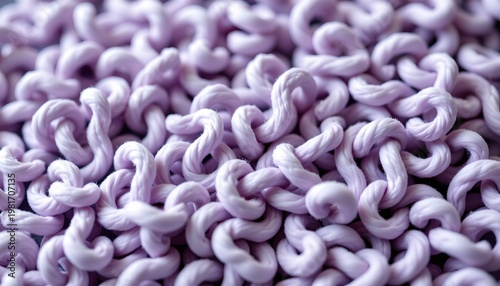 A close up view of an array of purple crocheted items, with their intricate patterns and textures creating a visually striking contrast against the dark background.