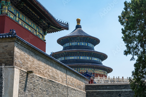 The iconic blue-roofed Hall of Prayer for Good Harvests rises majestically above ancient stone walls under a clear sky at the Temple of Heaven in Beijing.