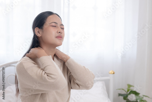 Tableau sur toile women sitting in bed touching her shoulder pain, morning muscle stiffness, neck and shoulder tension, poor posture, stress concept, healthcare, body discomfort