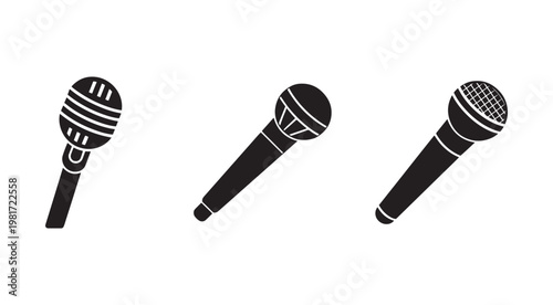 Three black microphones on white background for music performance and public speaking  various microphone designs