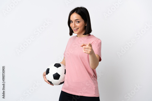 Young caucasian woman isolated on white background with soccer ball and pointing to the front