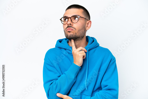 Young caucasian man isolated on white background With glasses and looking up