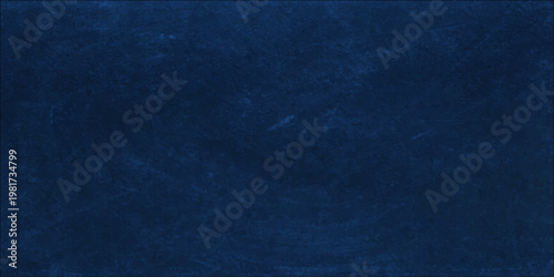 Dark blue grunge background featuring a rough denim fabric texture with vintage cotton textile patterns and a dark textured surface design