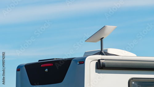Awning on side of caravan and Starlink terminal on roof