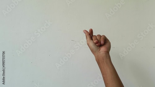 Close-up of a hand fingering against a plain white background