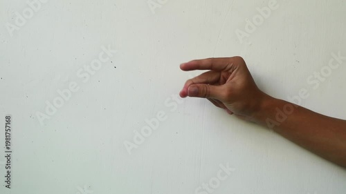 Close-up of a hand fingering against a plain white background
