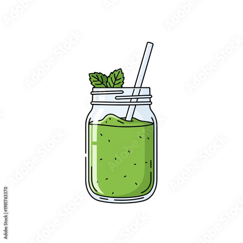 Fresh green smoothie in a mason jar with mint leaves and straw.