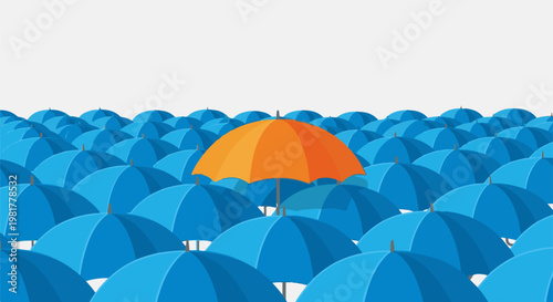 One orange umbrella stands out from many blue ones