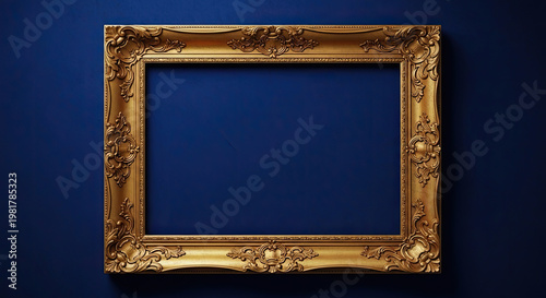 A gold picture frame with an ornate design against a dark blue background