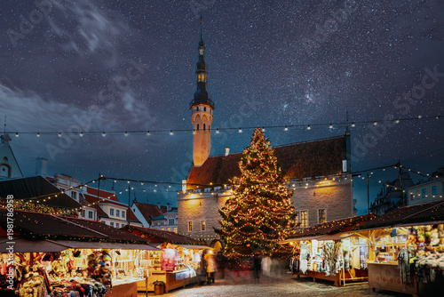 Illuminated Christmas Market and Town Hall in Tallinn Old Town under a starry night sky