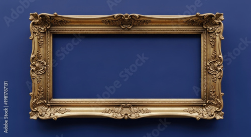 An ornate gold picture frame hangs on a solid blue wall