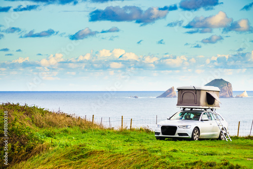 Car with roof top tent camp on sea shore