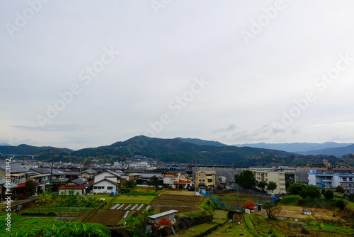 Panoramic rural town and farmland with mountains along Shikoku Henro route Japan