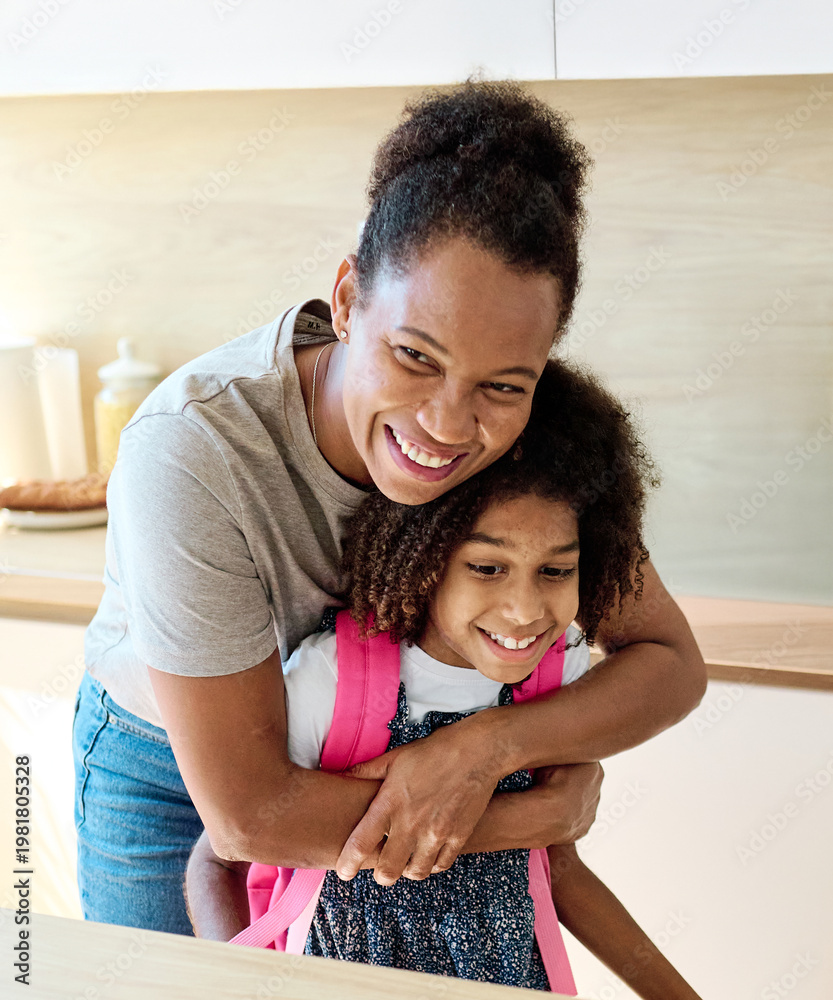 Obraz premium Mother helping daughter to get ready for school, helping her with backpack and books, and making snack sandwich in the kitchen hugging and leaving home